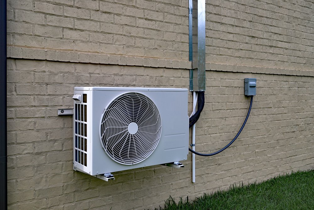 Outdoor unit of a split air conditioner mounted on an exterior wall
