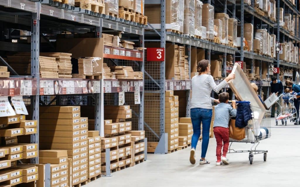 IKEA and Bauhaus shelves filled with products and a family