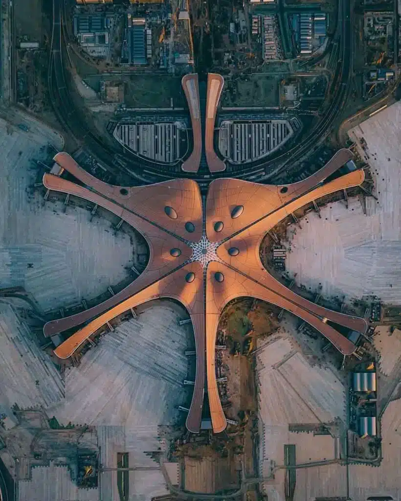 "Aerial view of Beijing Daxing Airport showcasing its radial star-like design with extended wings in all directions."