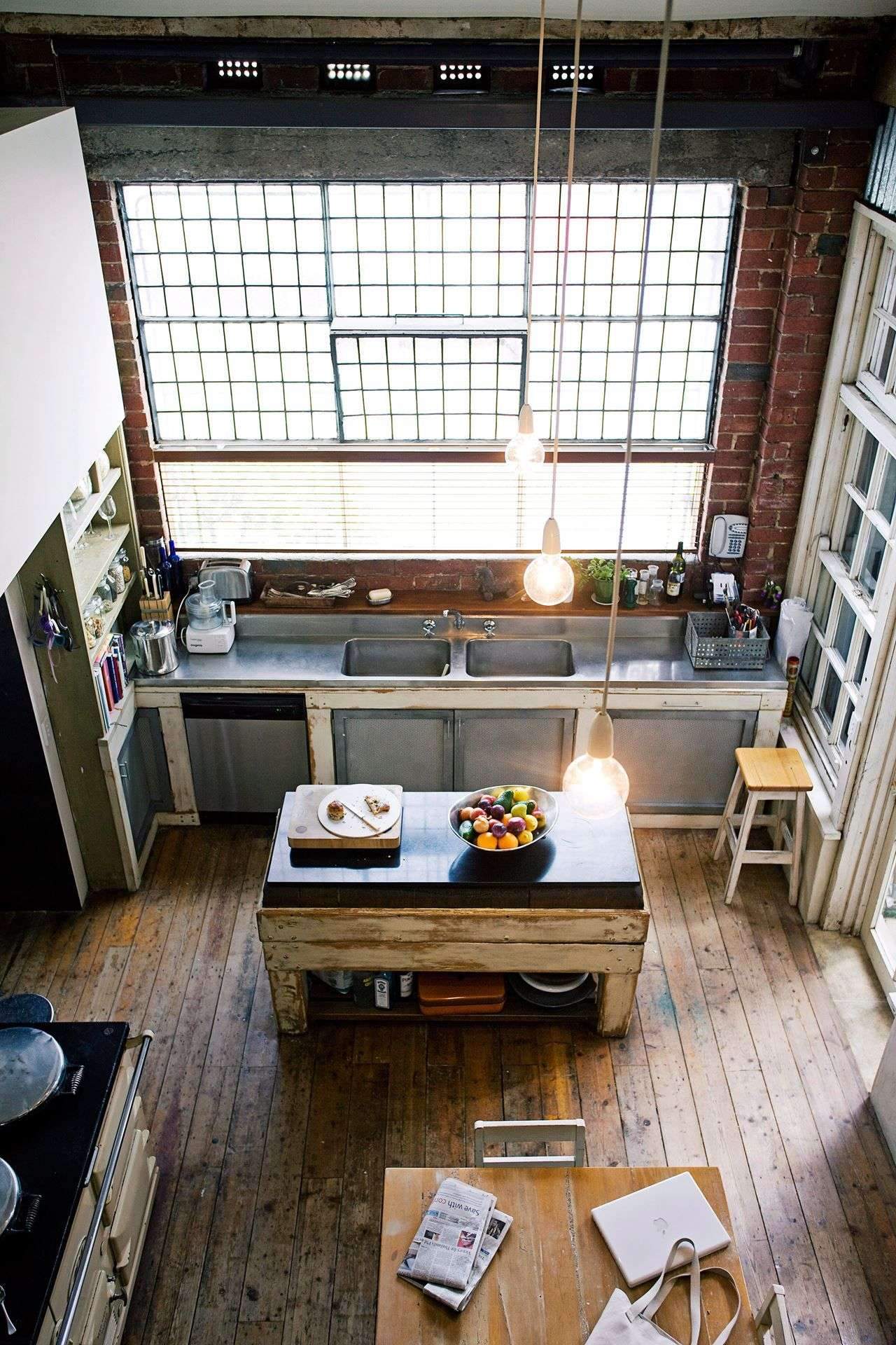 NYC is known for its loft apartments, converted from former factories. This kitchen combines…