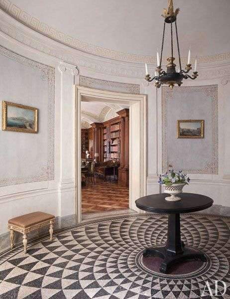 Paved with a Roman-inspired mosaic, the elliptical entrance hall of a Naples, Italy, apartment…