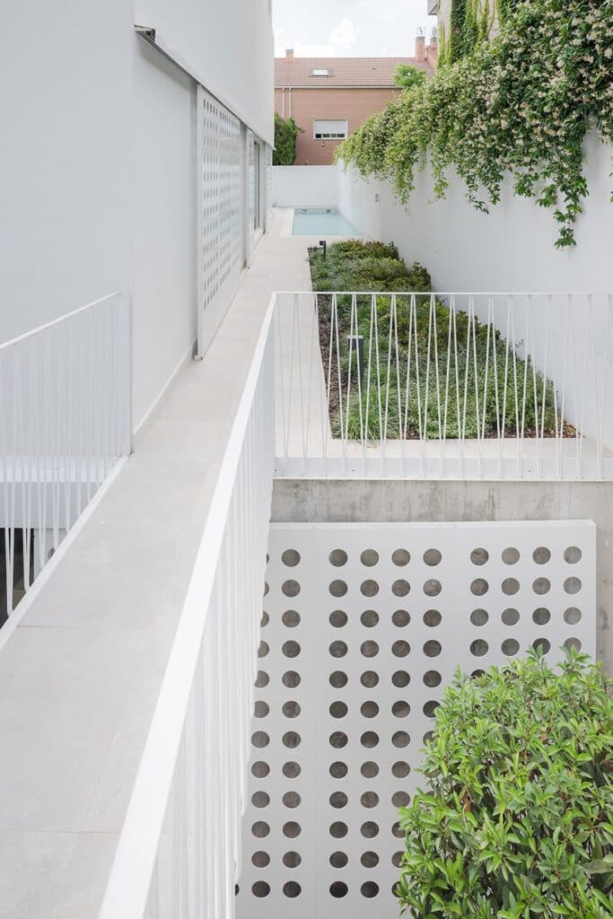 "Aerial view of a narrow house showing the garden and double-height balcony."