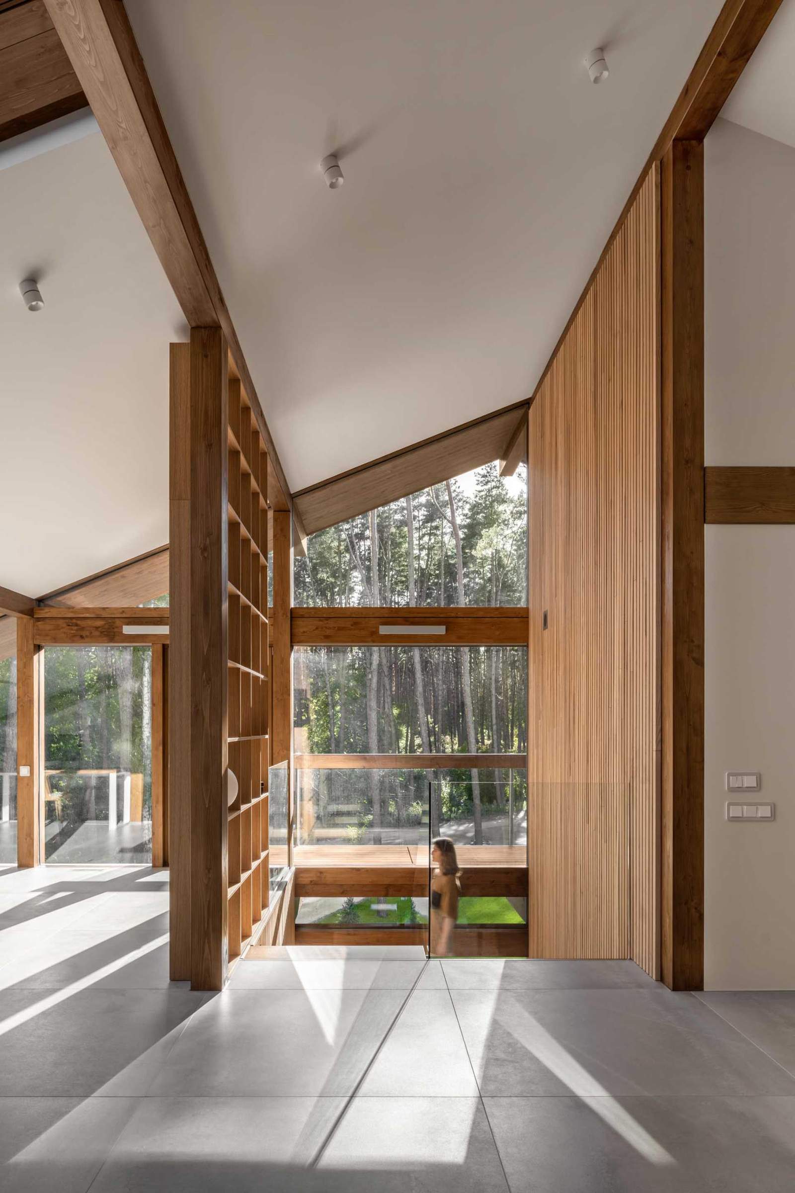 A modern wood staircase has a wood slat accent wall.