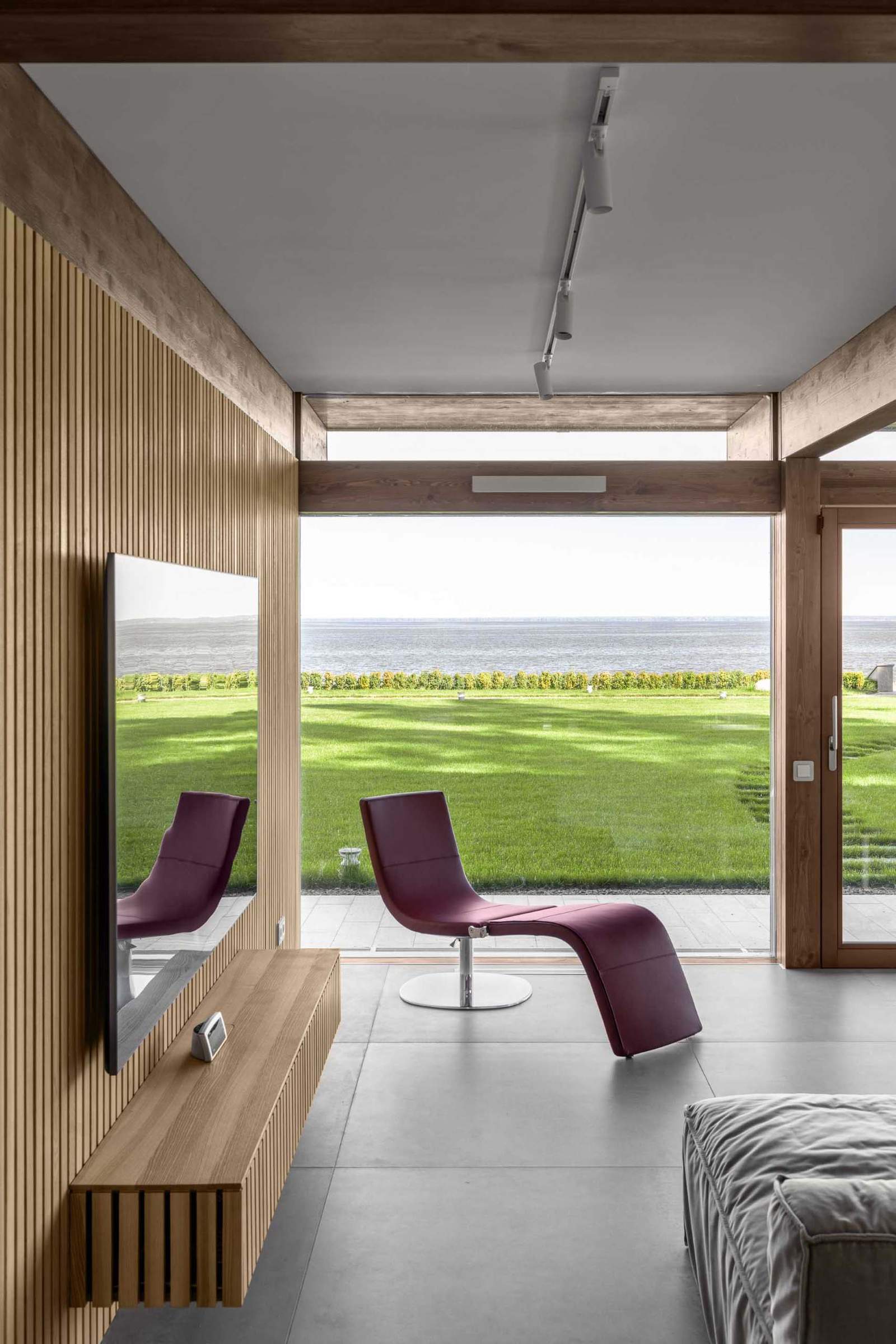 A modern living room with a wood slat accent wall behind the tv.