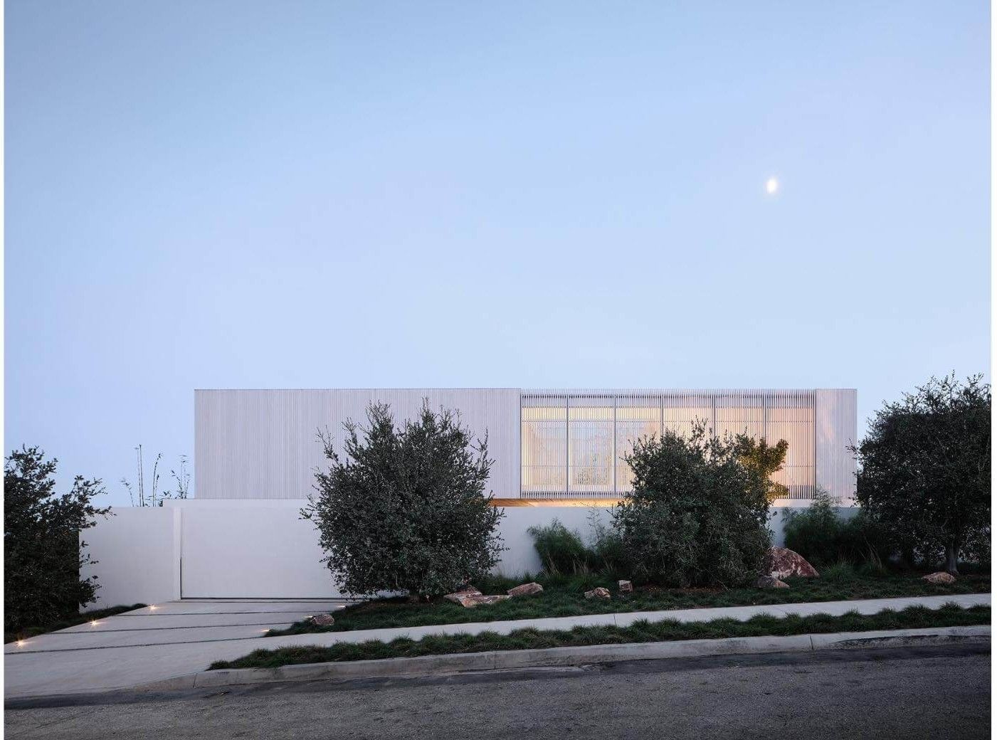 a sleek modern home as seen from a street