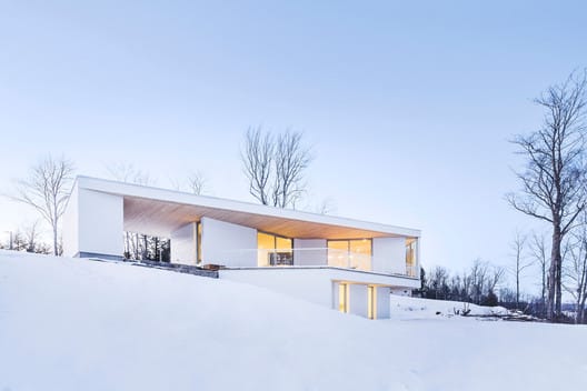 "A modern home showcasing innovative design in a snowy natural landscape"
