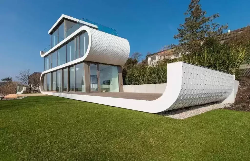 "A modern home showcasing a curved design with a glass facade"