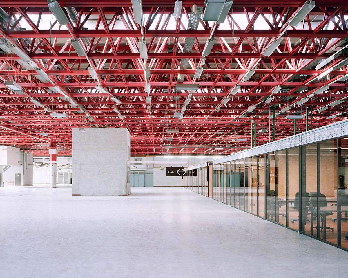 Converting an industrial building into a pink steel-roofed workspace