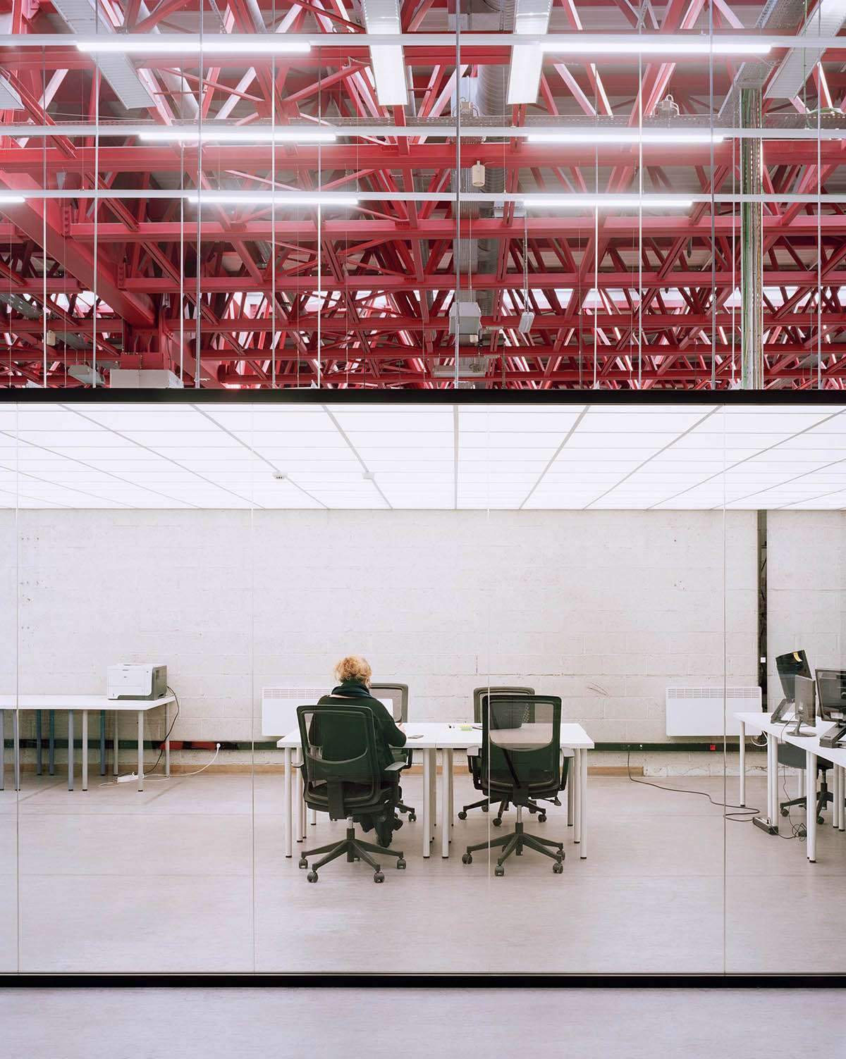 Converting an industrial building into a pink steel-roofed workspace