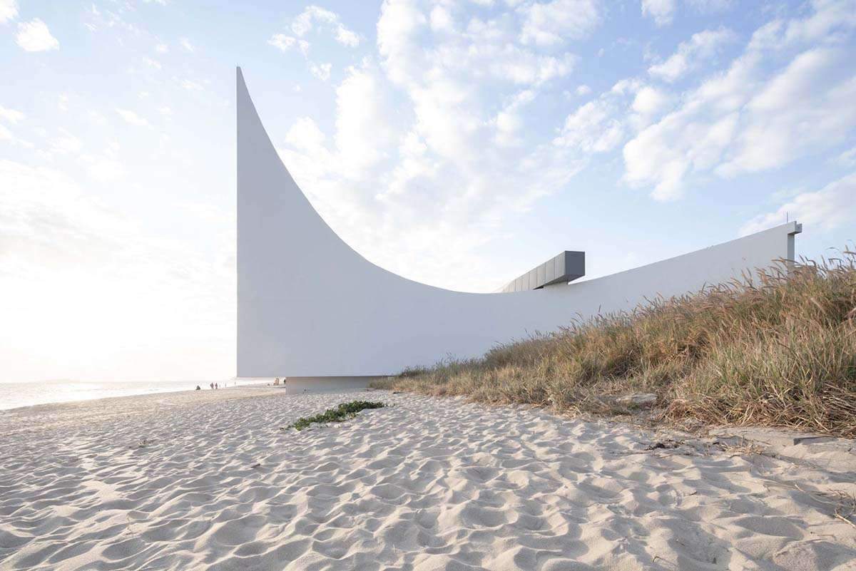 Zigzag church design with vertical window on the seashore