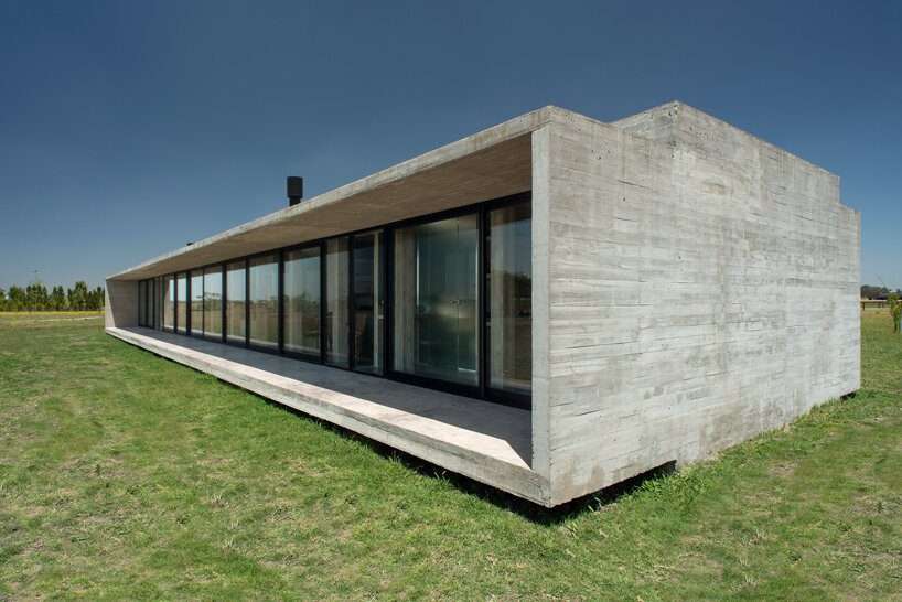 luciano kruk shapes one long concrete volume for 'countryside house' in argentina