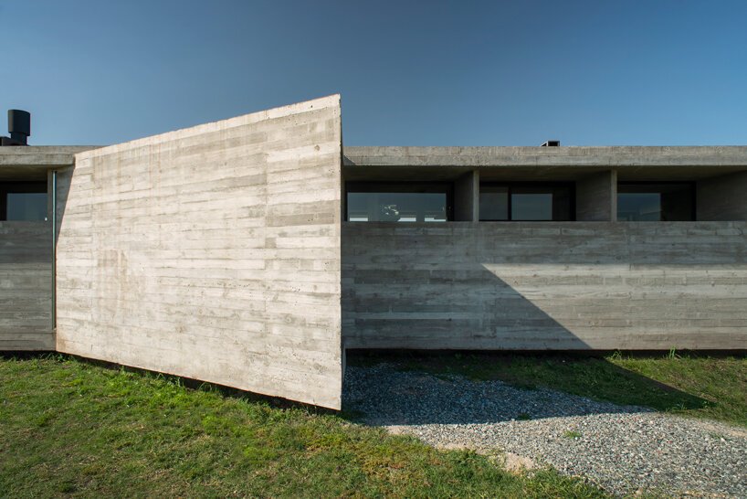 luciano kruk shapes one long concrete volume for 'countryside house' in argentina