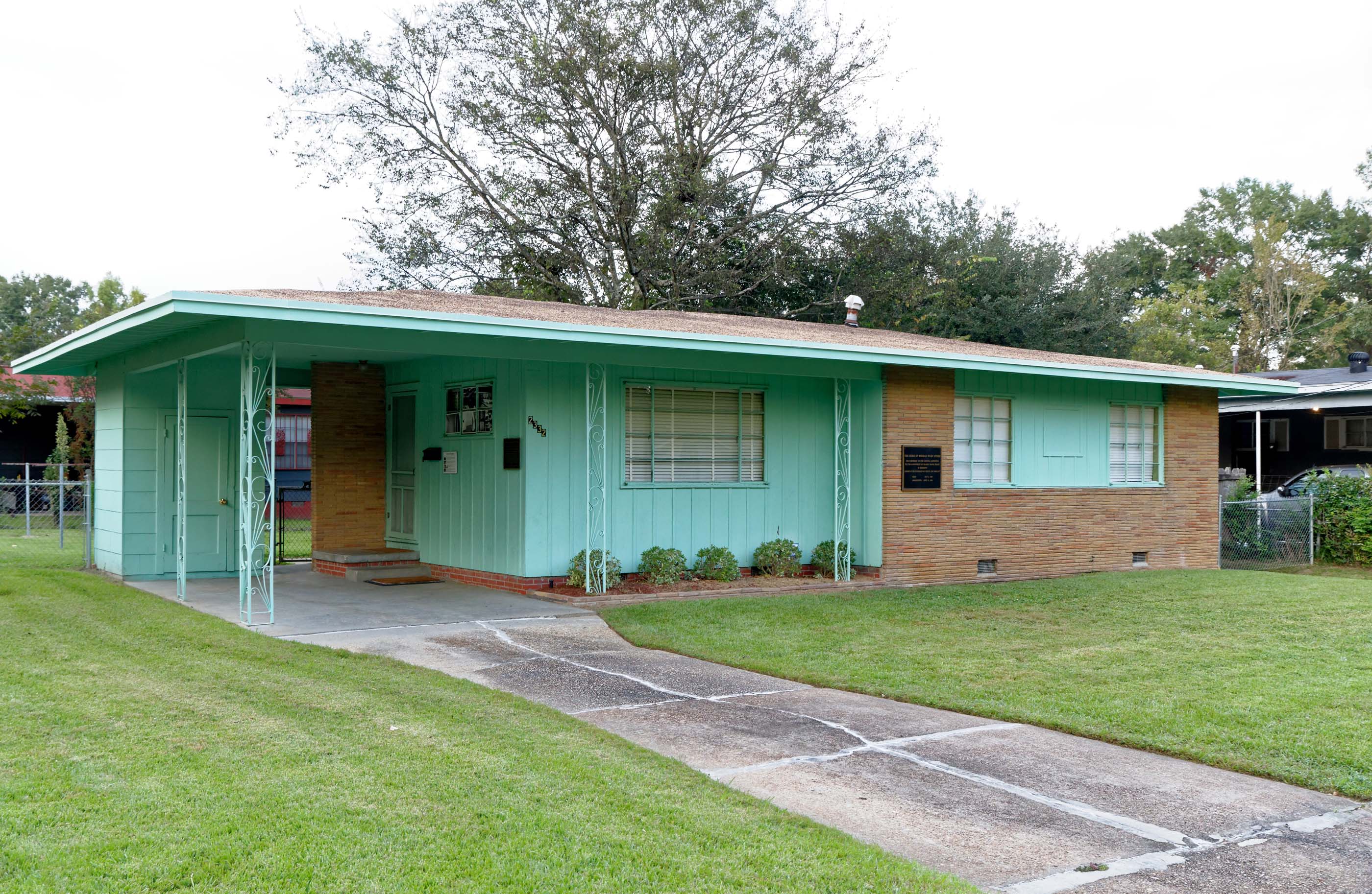 teal green and brick house