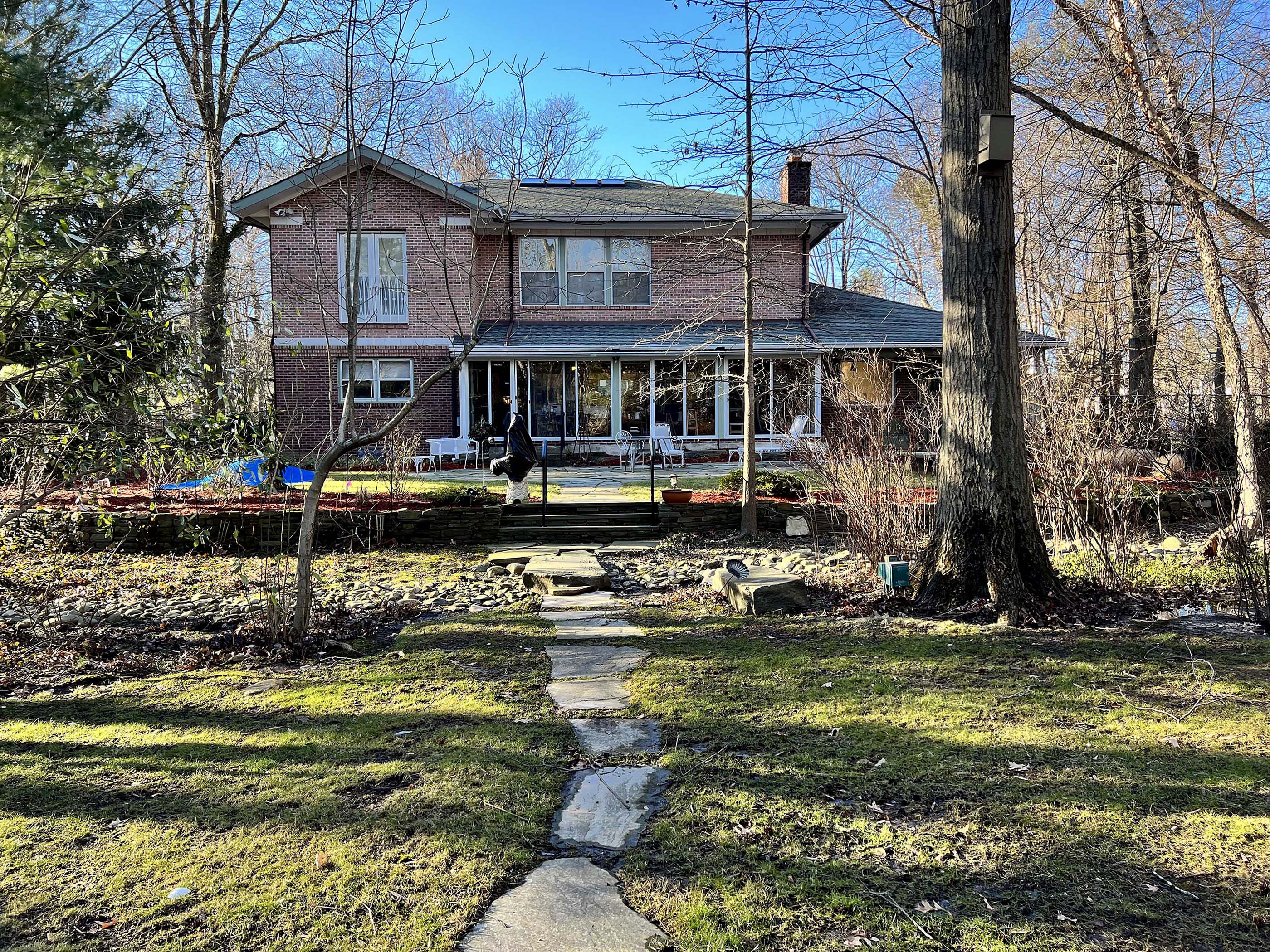 brick house on expansive grass lawn