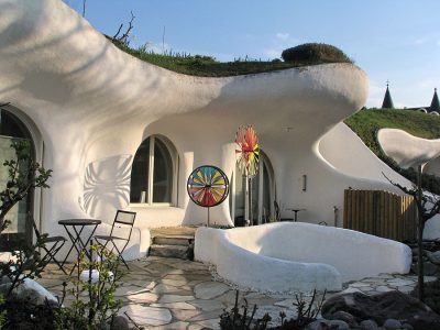 منطقة خارجية لبيوت الأرض مع تصميم منحني ومساحة جلوس في ديتيكون، سويسرا