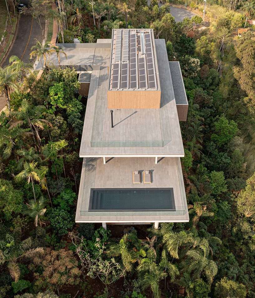 stilted 'minas house' by studio MK27 rests amid a rainforest garden in brazil