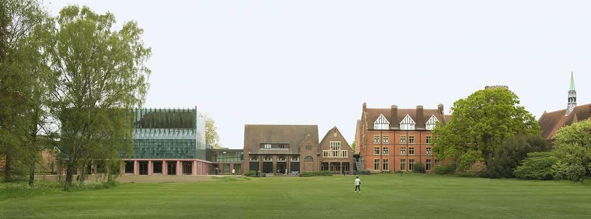 Completion of a dining hall wrapped in green faience tiles at the University of Cambridge