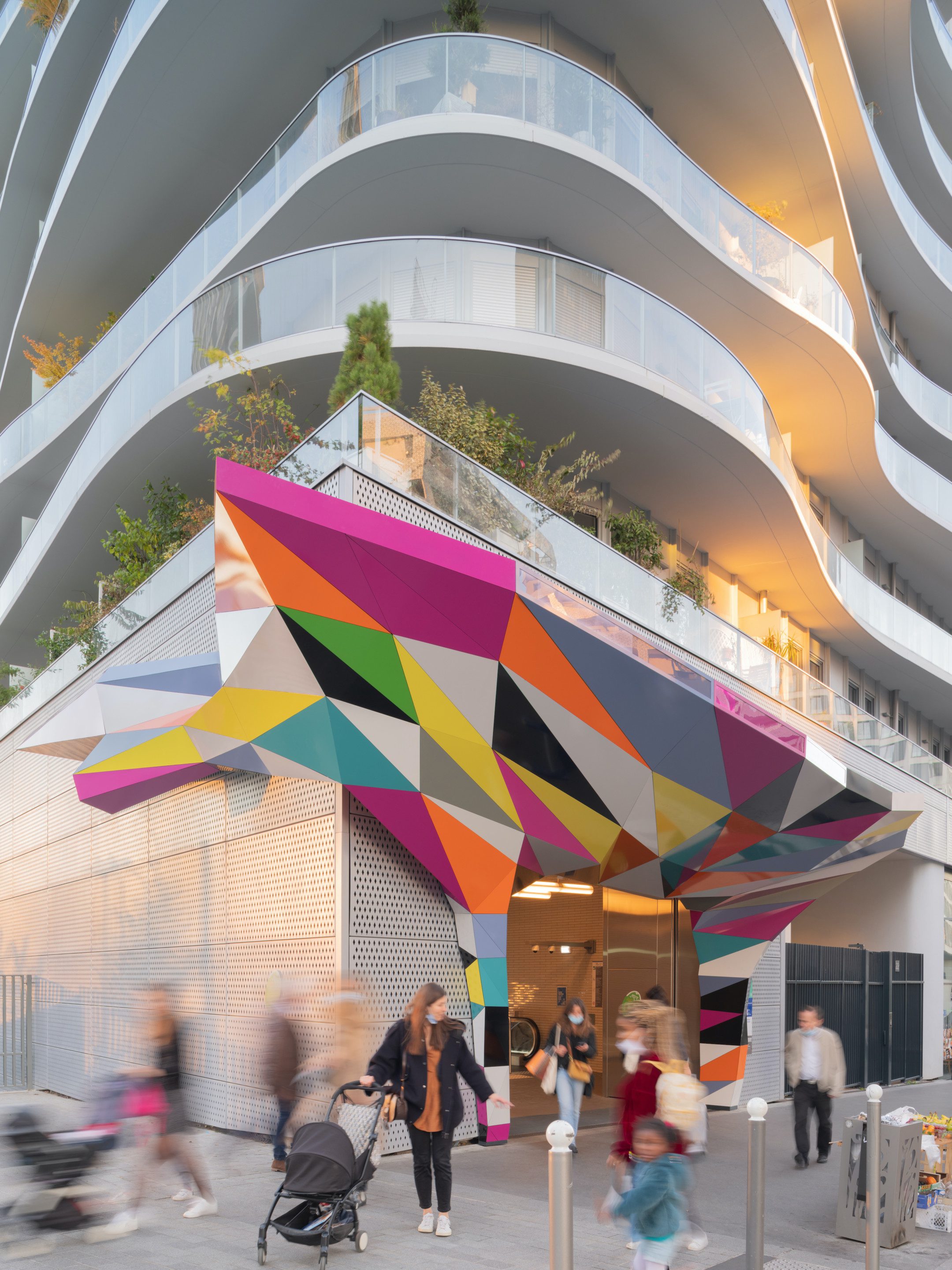 a colorful sculptural installation topping a metro entrance in paris