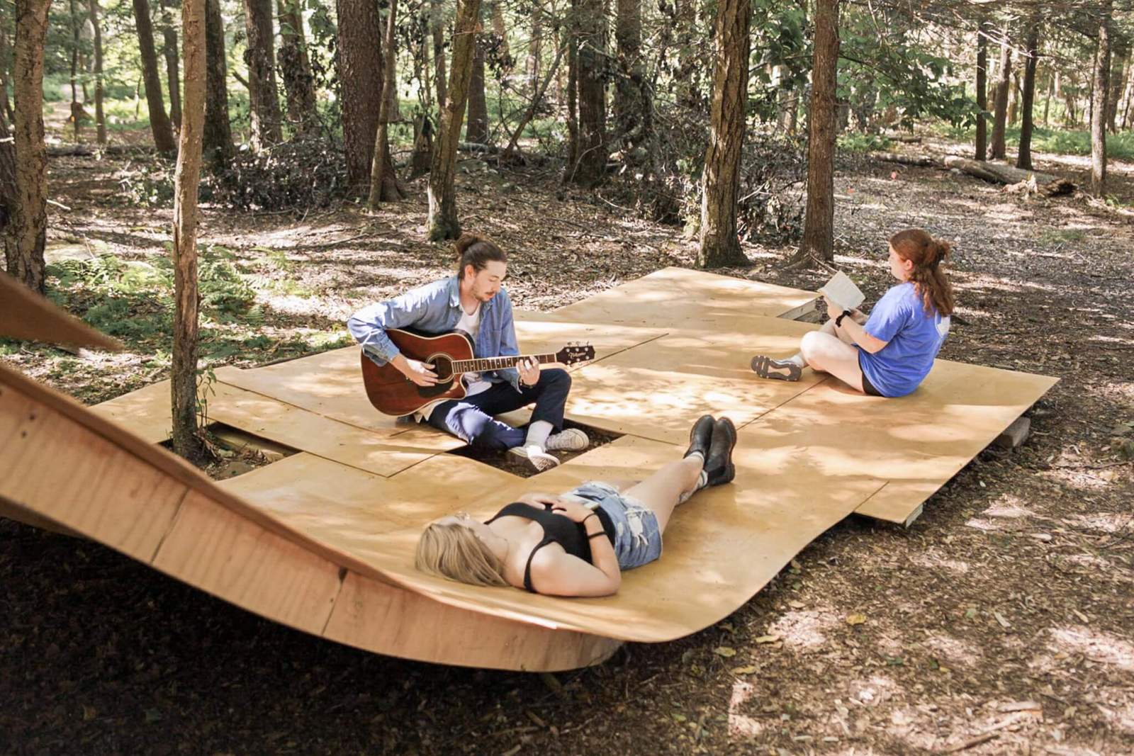 people on wood pavilion in the woods