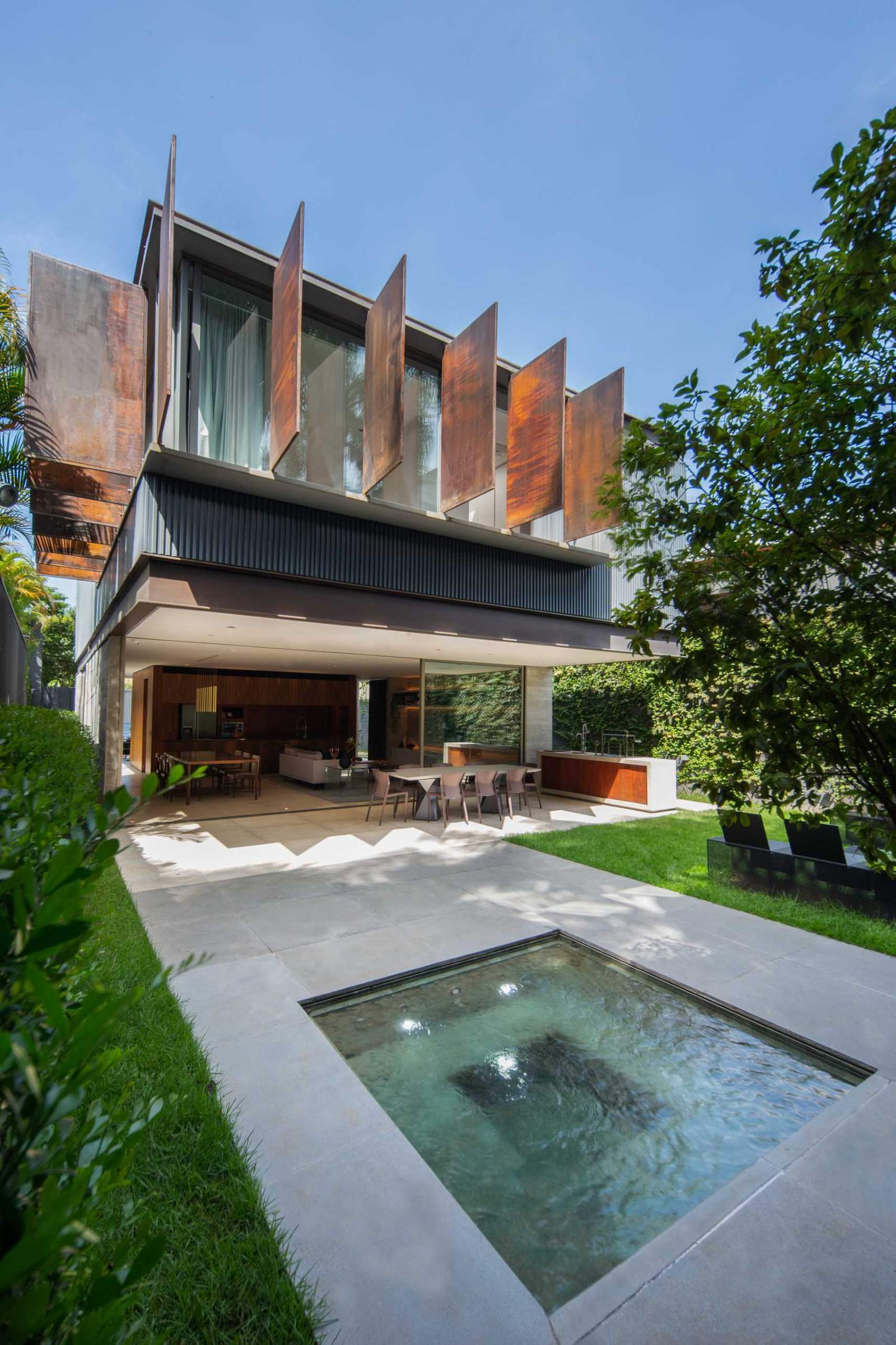 This modern home featured large metal shutters that provide privacy, shade, and help with ventilation.