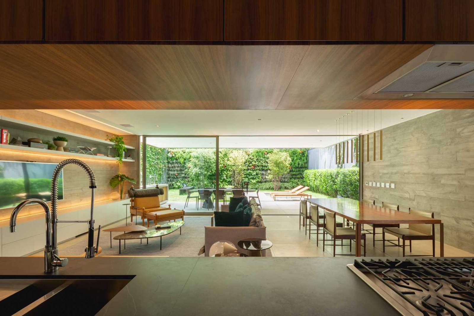 This kitchen has a view of the living room, dining room, and backyard.