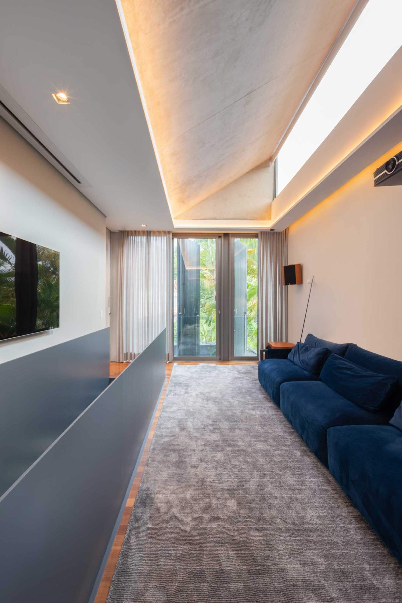 A home theater has been added in a narrow space at the top of the stairs.