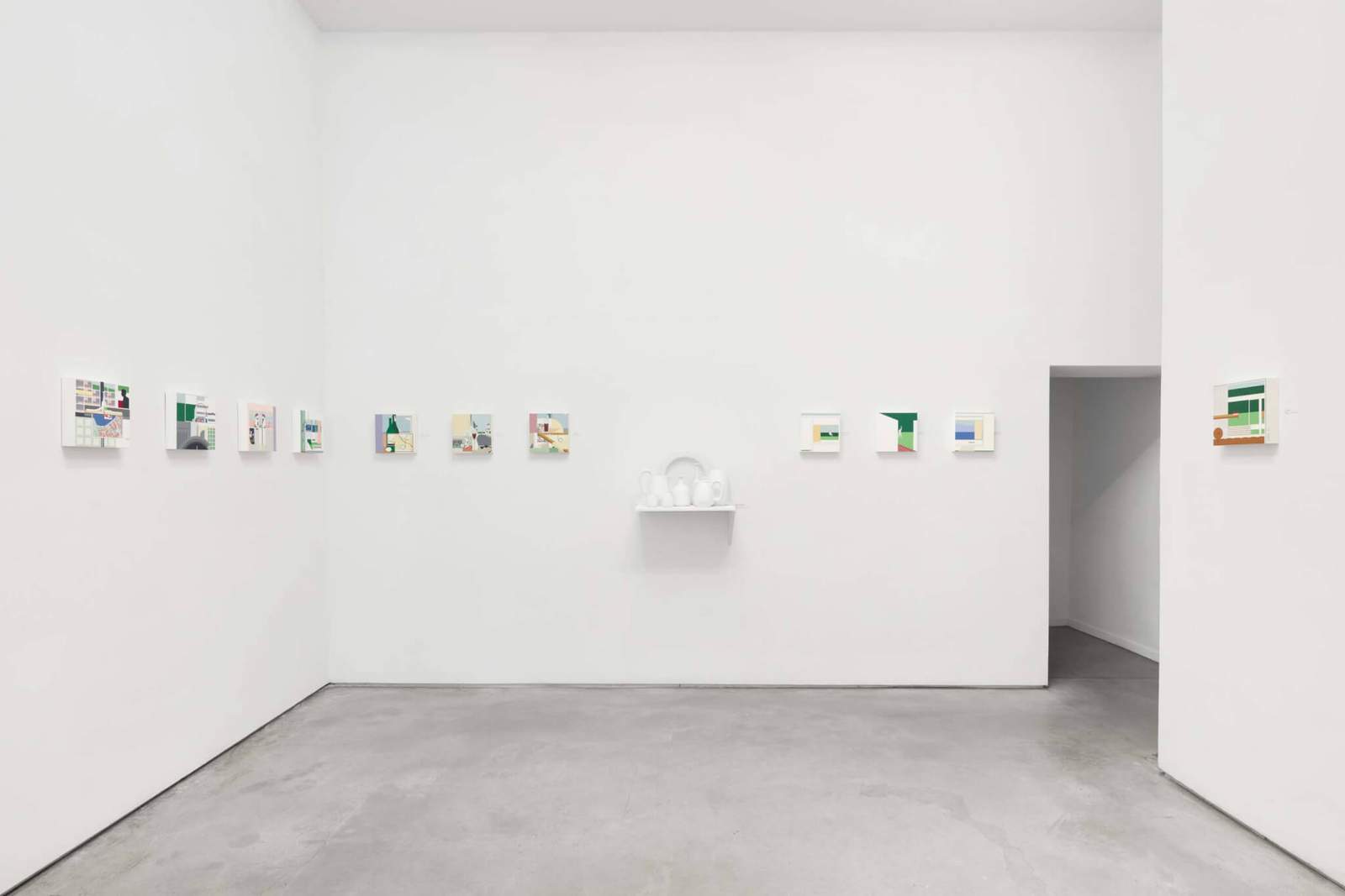 exhibition view of fifty paintings small paintings hung on wall
