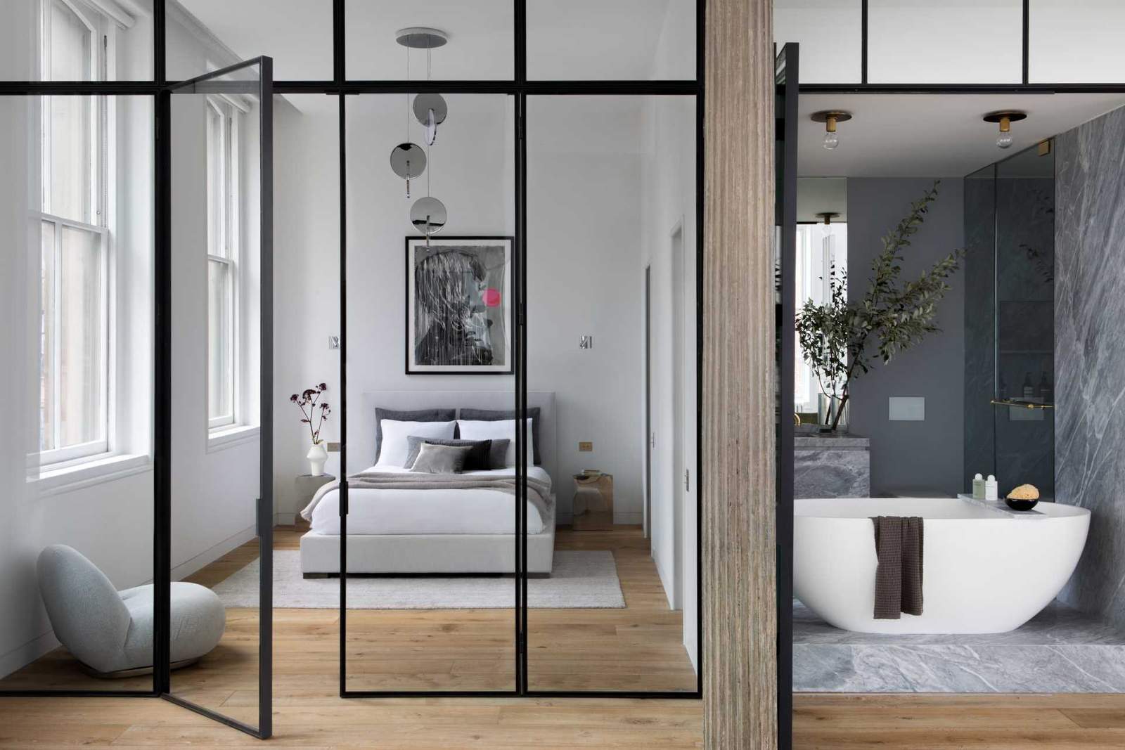 This modern en-suite bathroom can be accessed via a door in the bedroom, or through the large opening with a mirrored triple-bifold door.