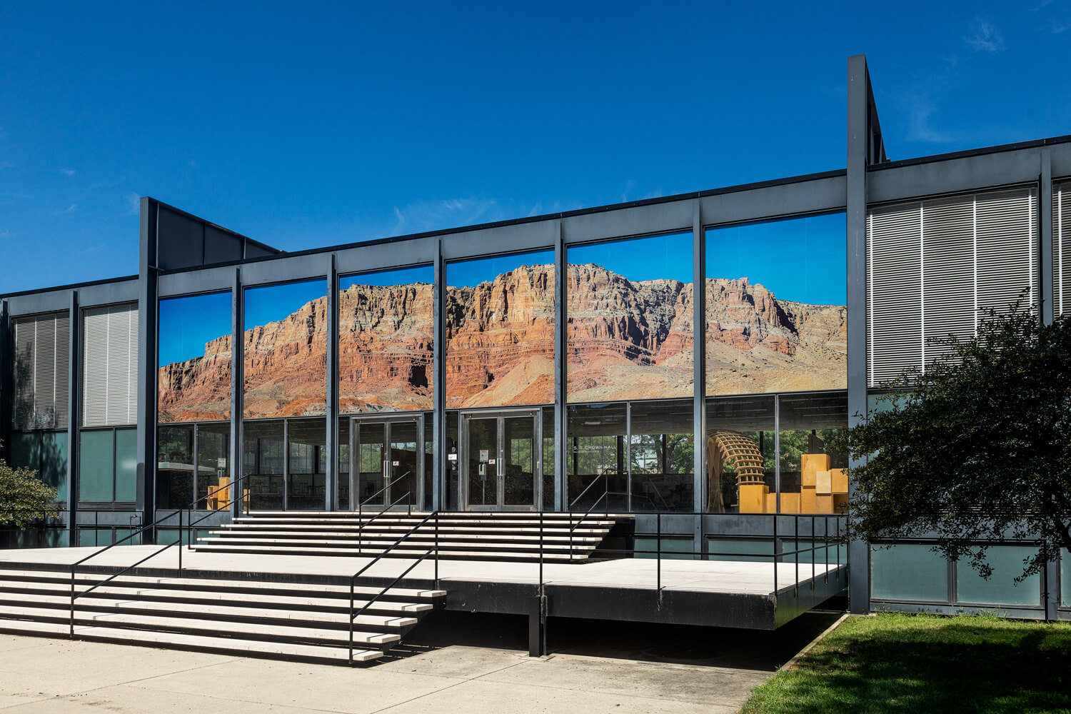 a mountainous collage installed on a mies van er rohe building