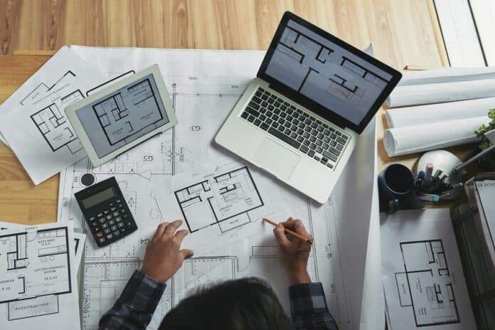 Do You Need A Specific Laptop For Architecture 1 Professional architect making corrections in apartment blueprint, view from above. Do You Need A Specific Laptop For Architecture.