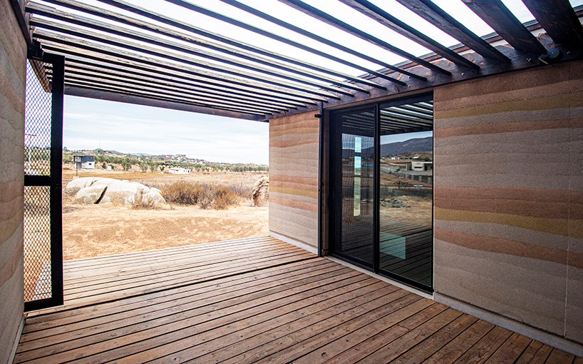 rammed earth and burned wood walls house 10
