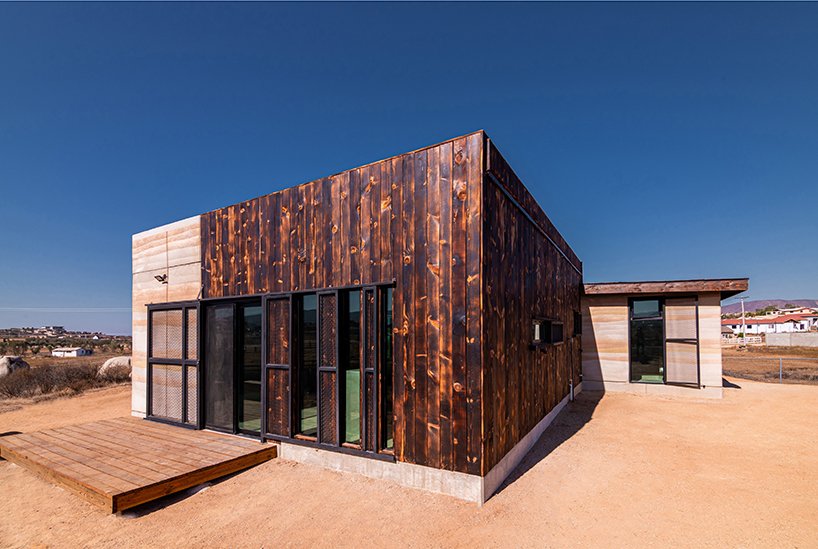 rammed earth and burned wood walls house 2
