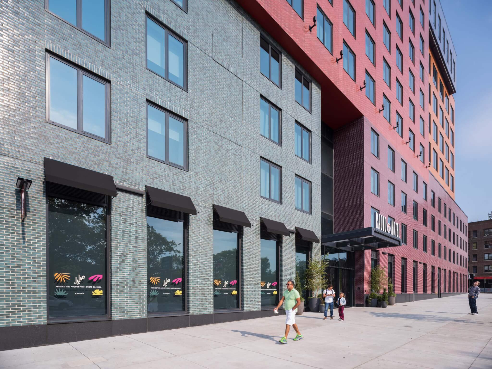 street view of radio hotel and tower showing brick facade