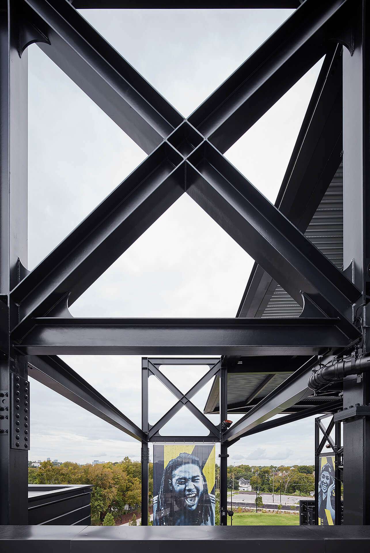 an exposed steel structure with banners of sports fans
