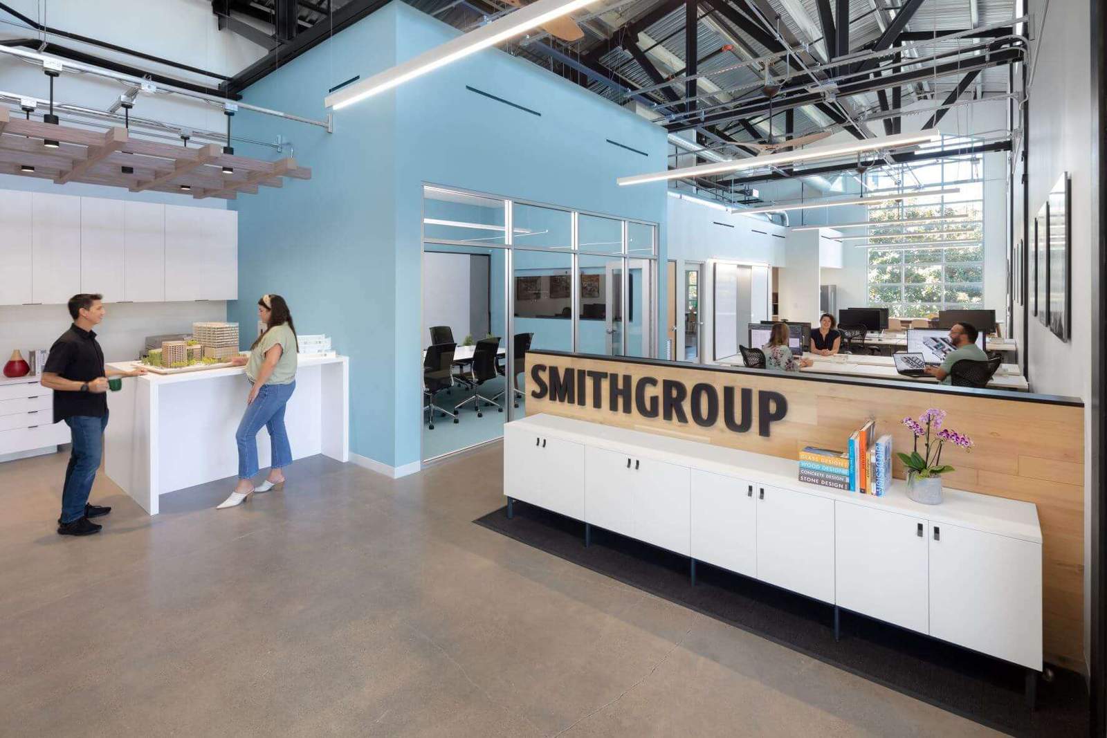 office with blue walls and wood desk and white cabinets