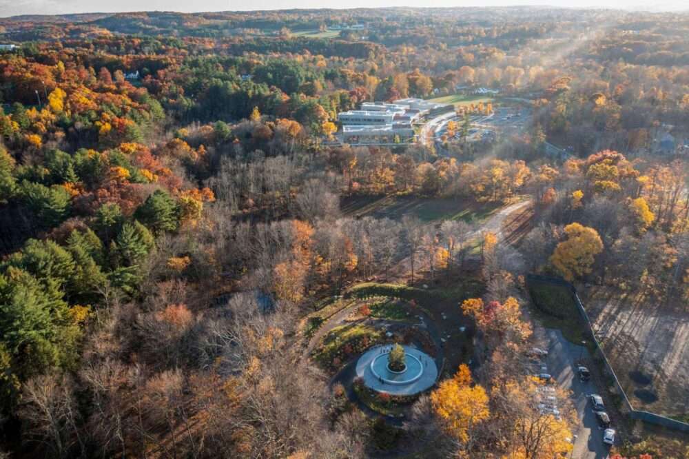 aerial view of Sandy Hook memorial surrounded by trees with elementary school nearby