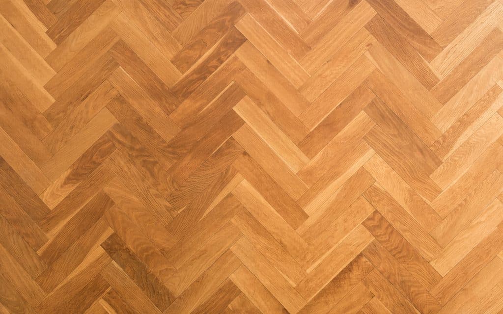 Parquet wooden flooring in herringbone pattern.