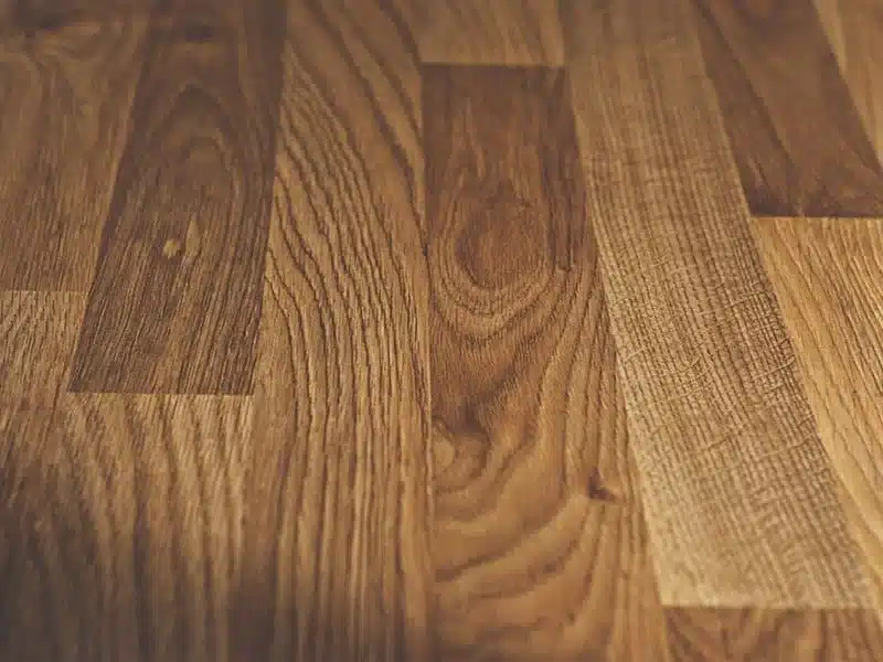 Solid hardwood flooring with scratch-resistant coating.