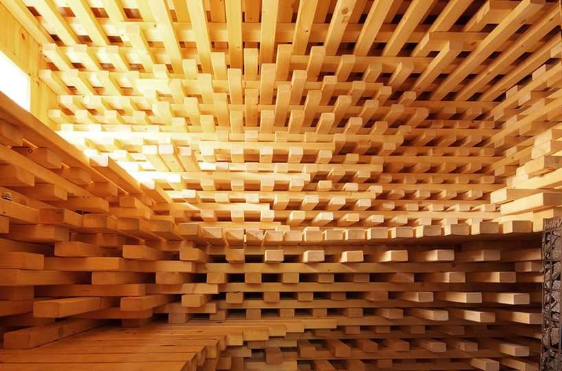 intertwined wooden beams sculpt sauna chamber by anders berensson architects in norway