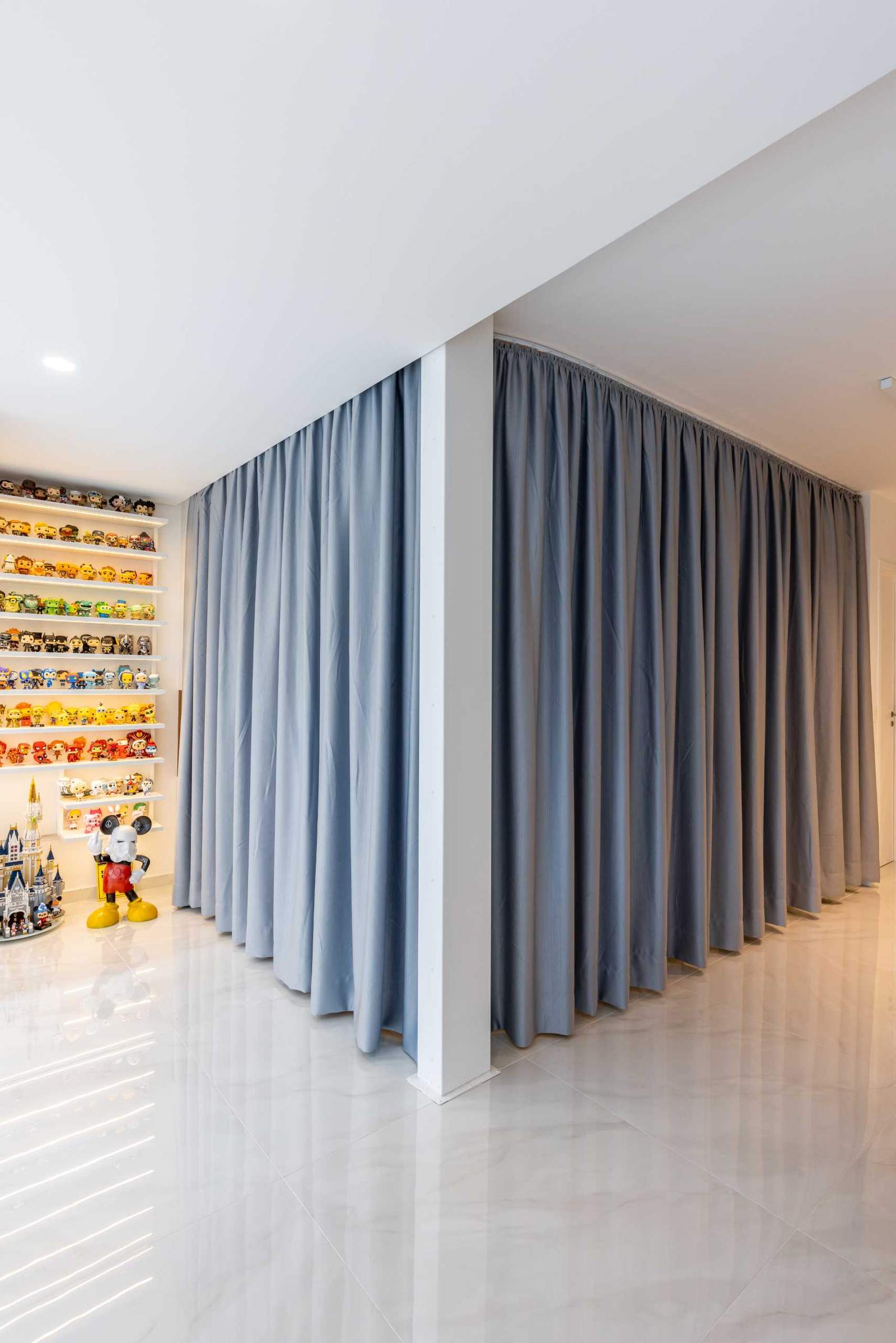 A modern open-plan bedroom with curtains for walls.