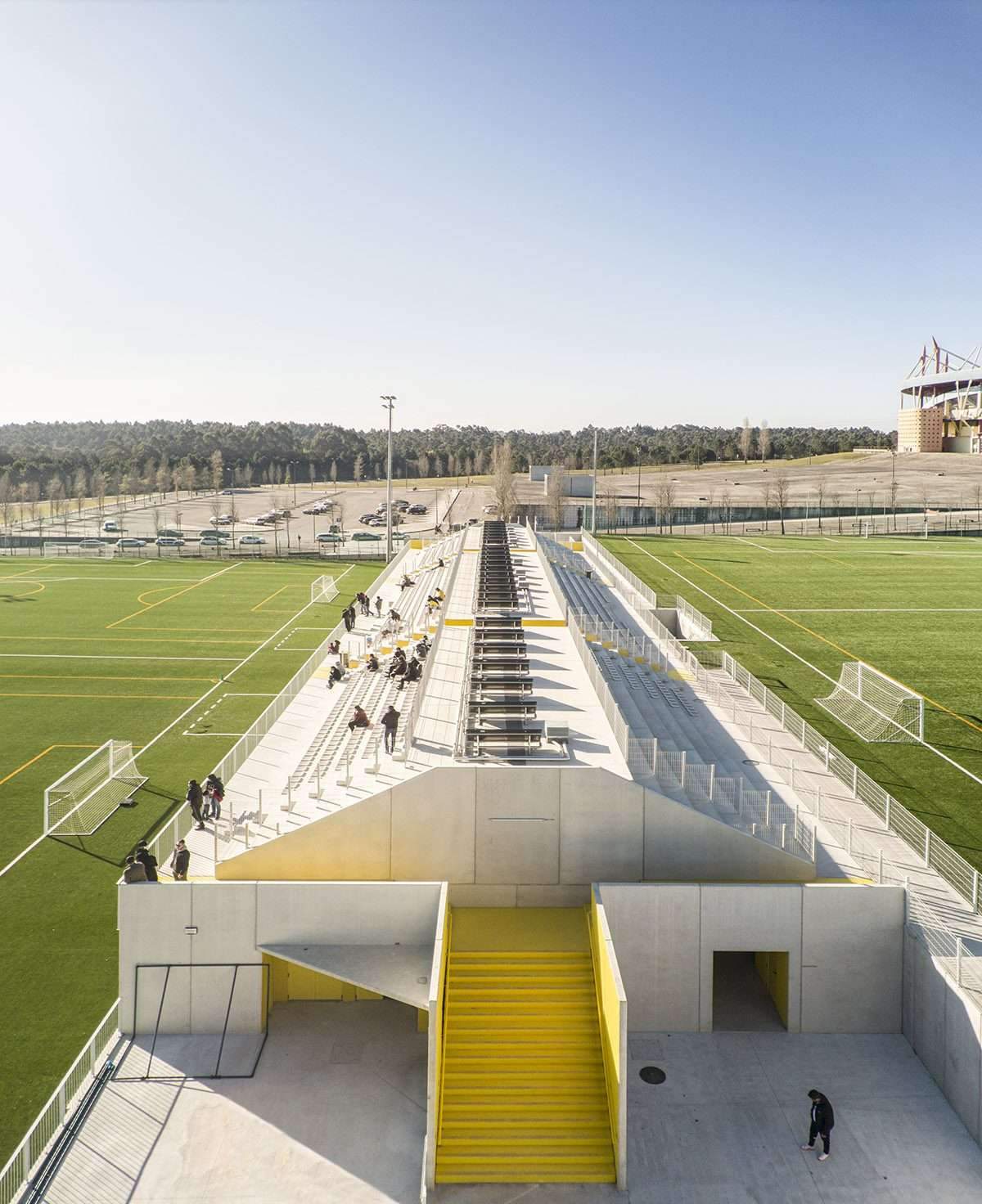 Create a summary highlighting the public spaces of the stadium's training facility in yellow