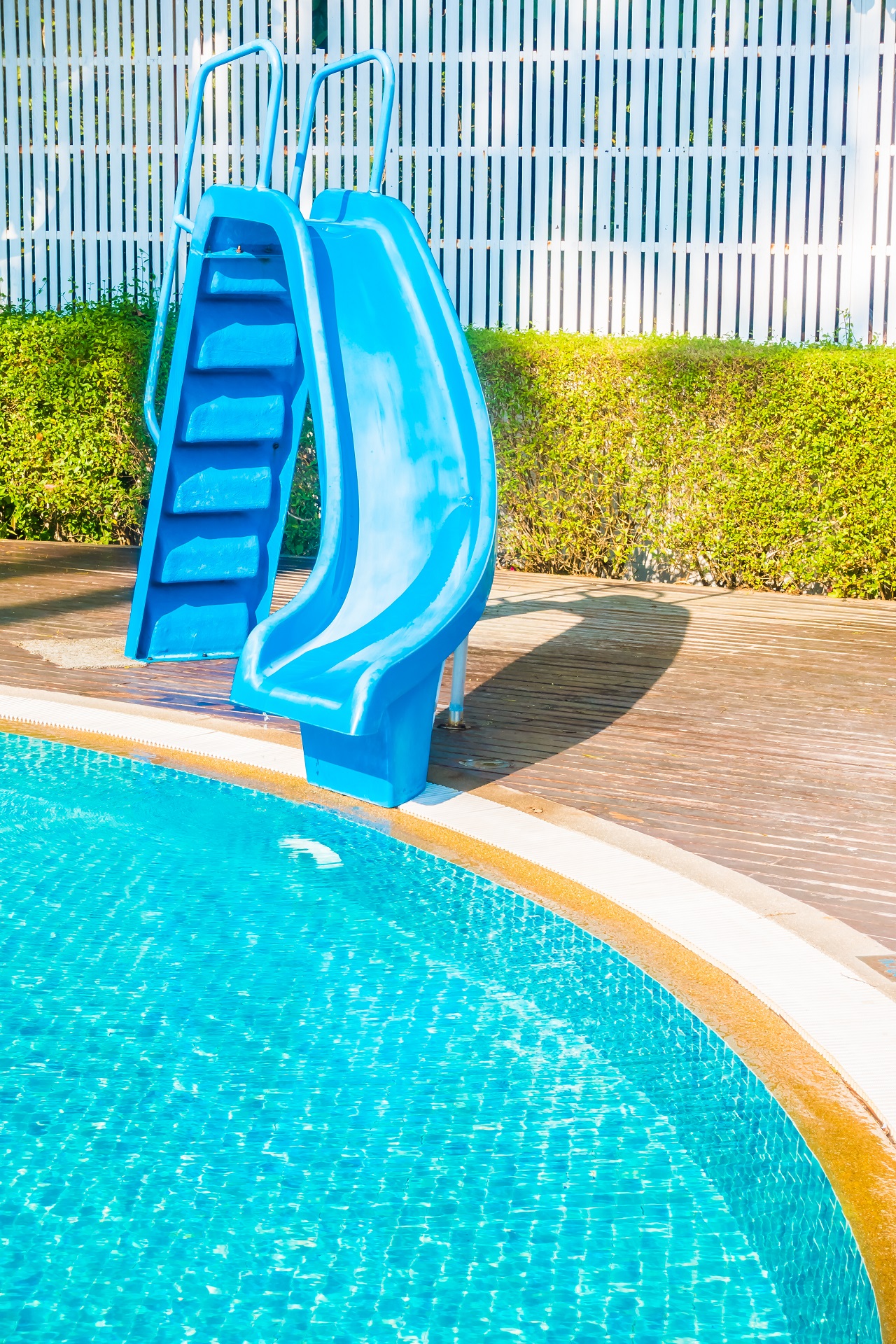 Silder around swimming pool. Swimming pool with an attached slide.