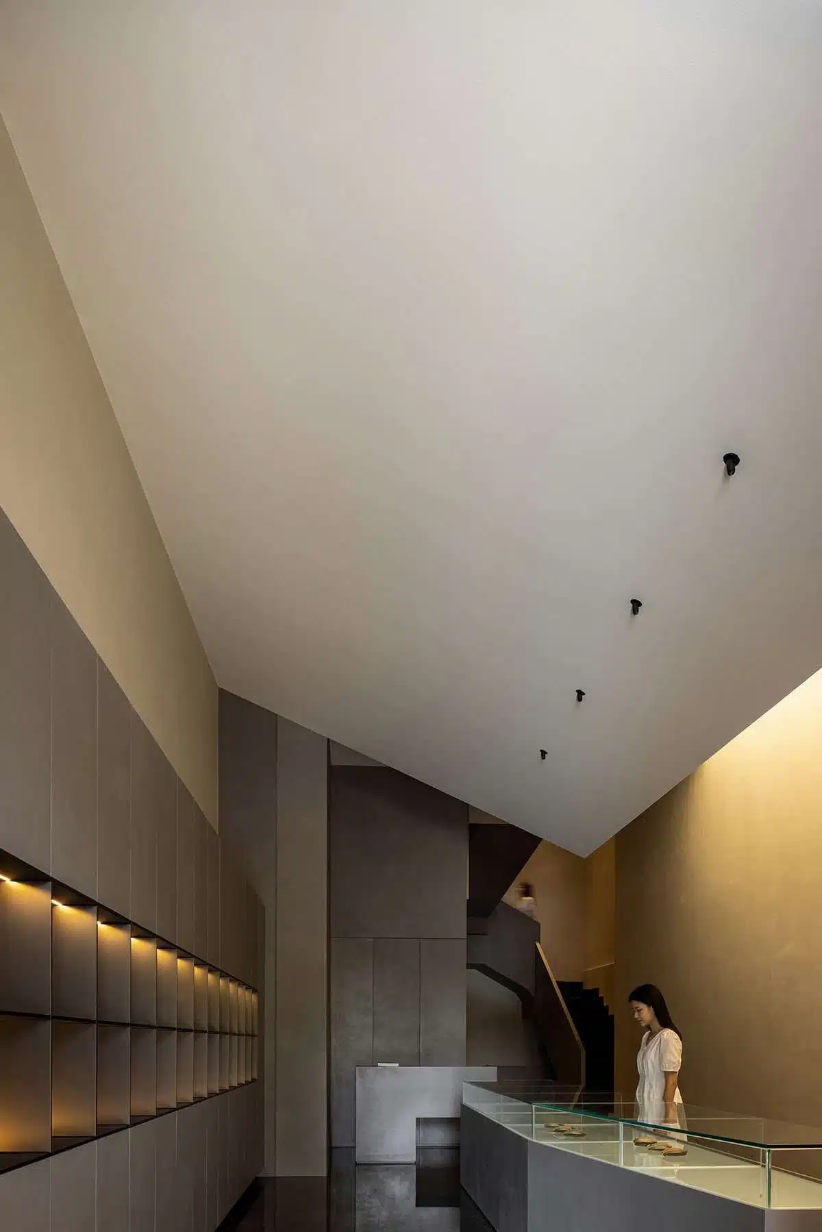 Abalone showroom design with floating blocks and golden colors