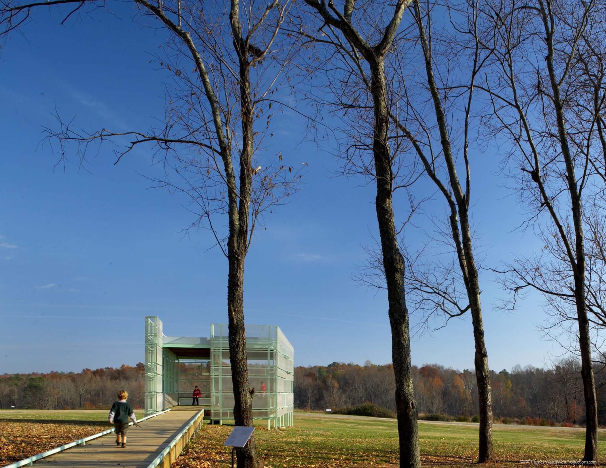 green structure with broadwalk in open field