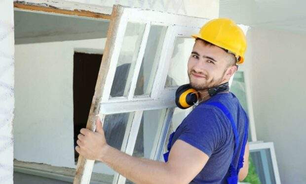 Man about to install a window