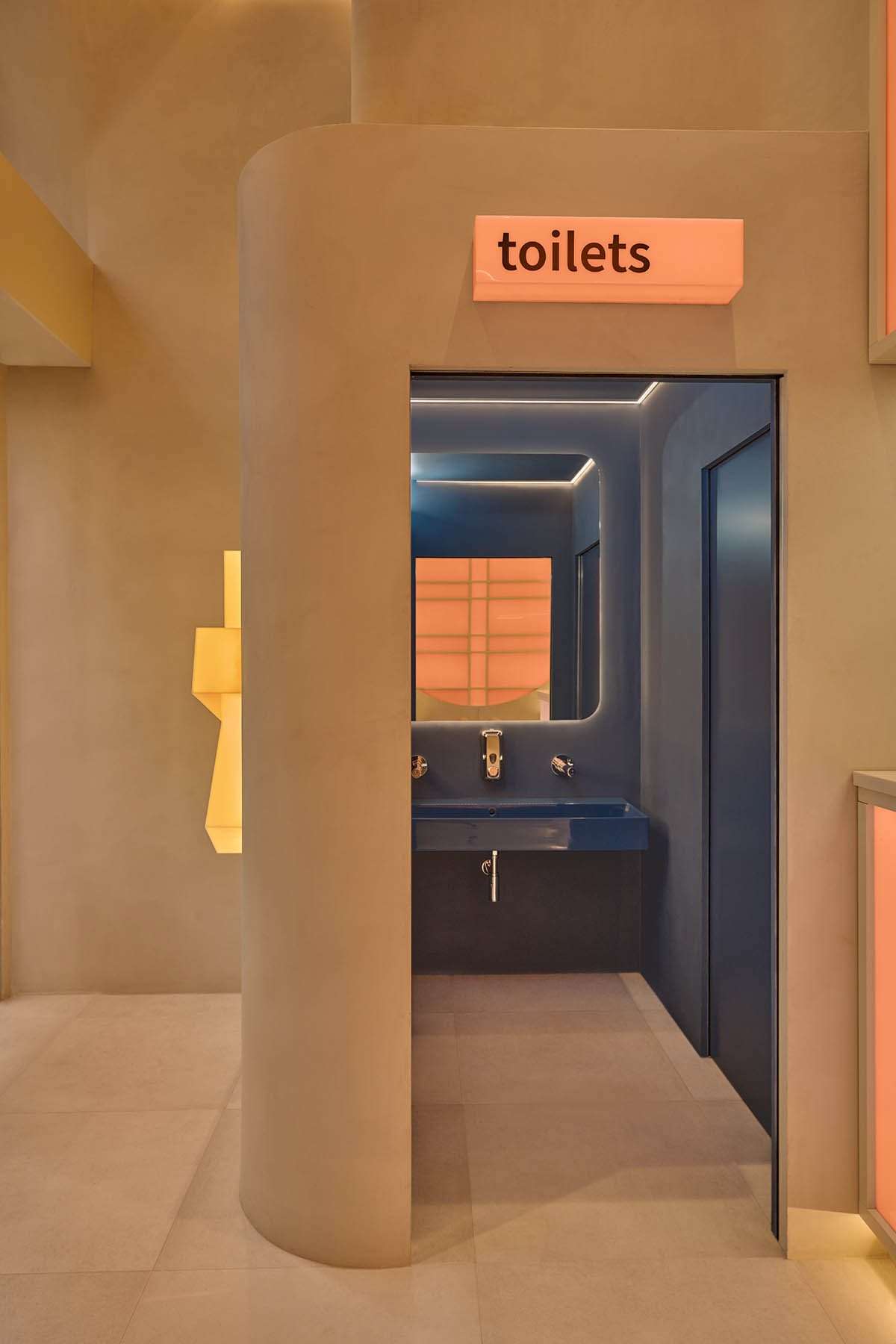 The design of the sushi restaurant in light orange colors and geometrics in Milan