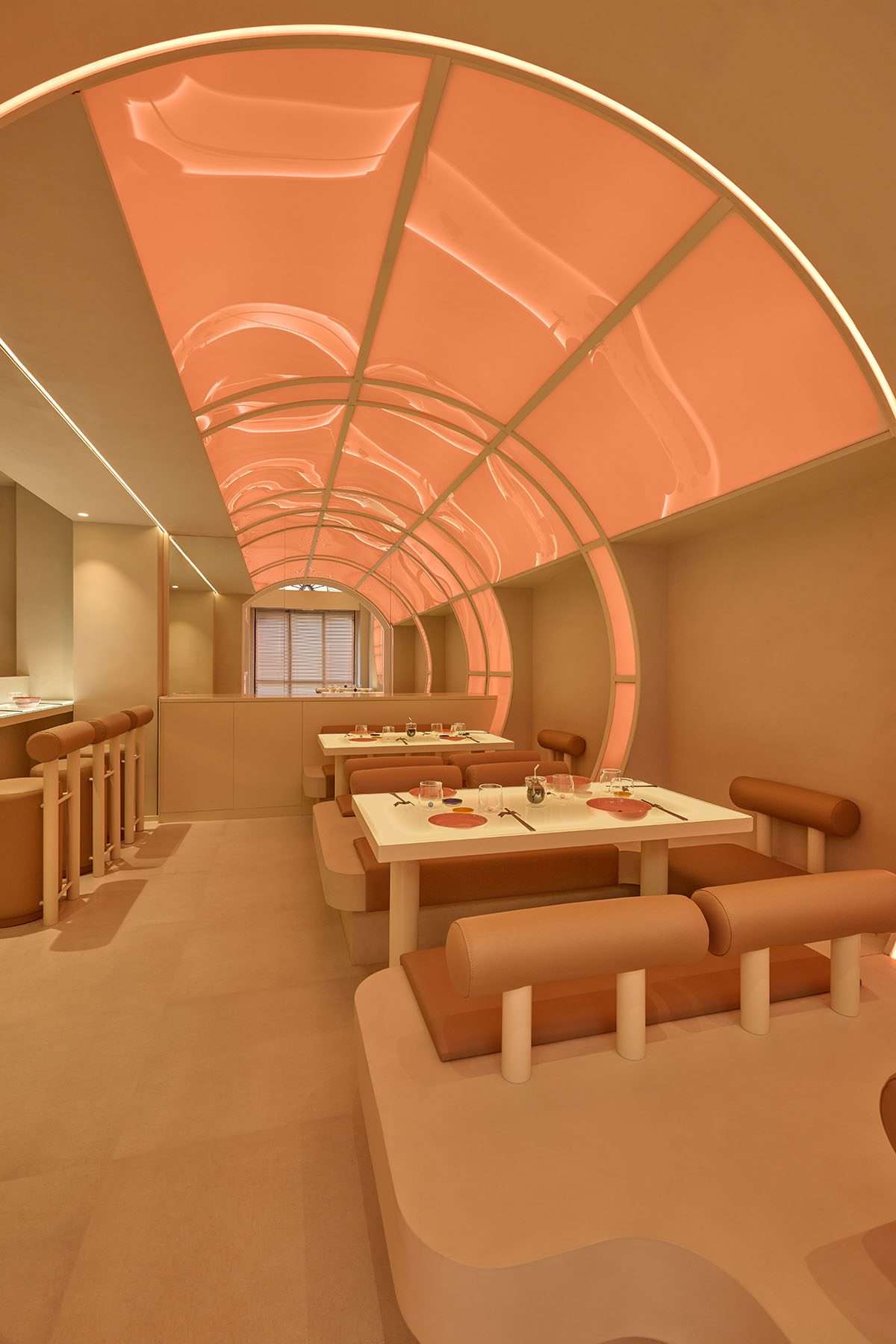 The design of the sushi restaurant in light orange colors and geometrics in Milan