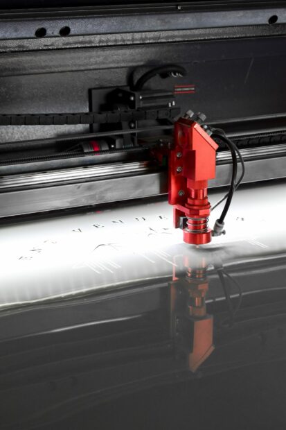 How Much Does A Laser Engraver Cost: Facts, Faqs, And Guide 1 Laser engraver engraving on a silver metal