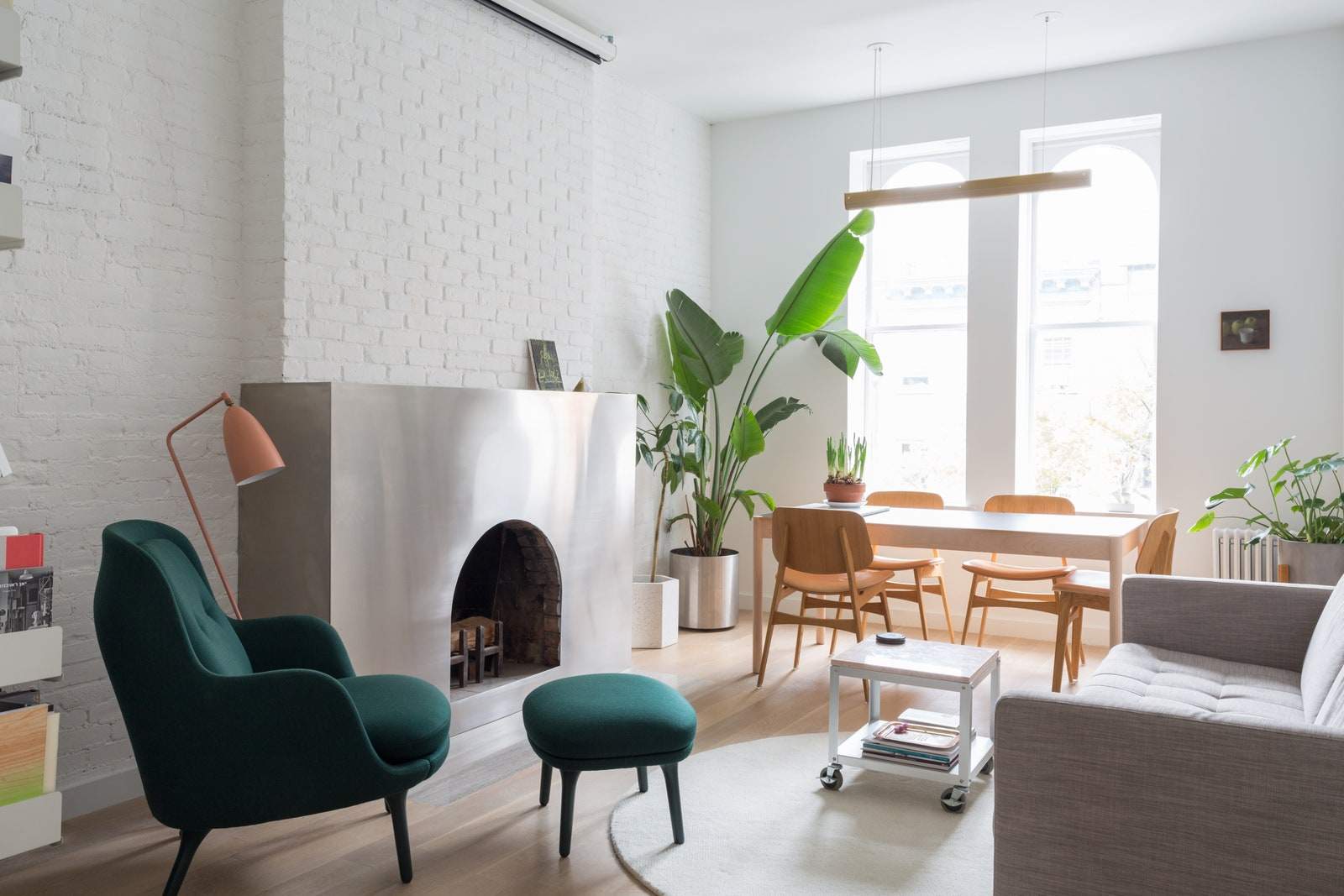 Stainless steel surrounds the fireplace in this Chelsea apartment by Bond making the space even brighter.