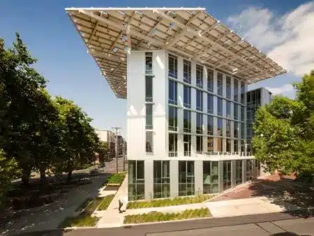Building equipped with solar panels on the roof for renewable energy generation.